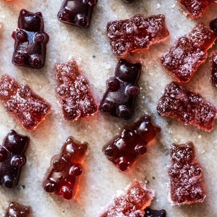 Overhead shot of sour and raspberry keto gummies on marble