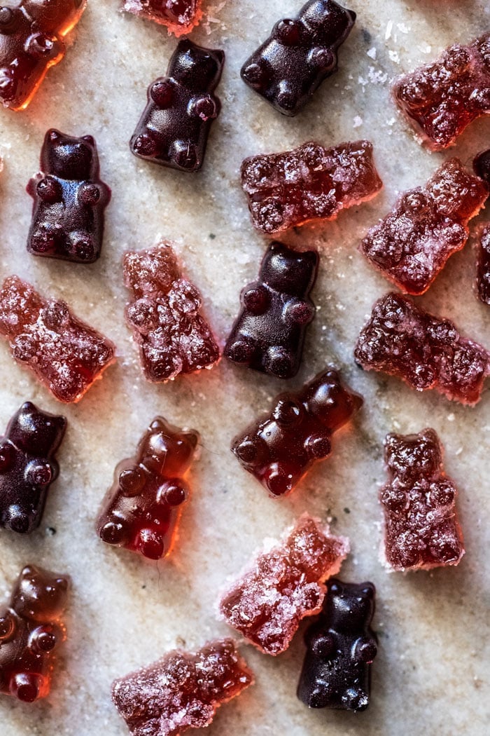 Overhead shot of sour and raspberry keto gummies on marble