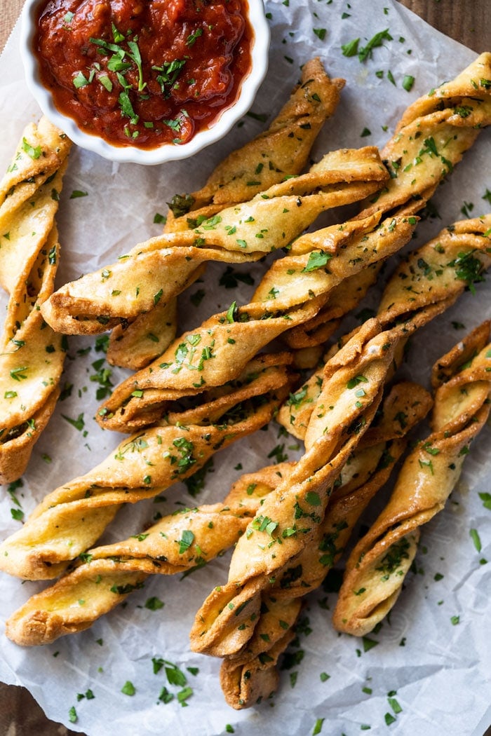 Garlic keto breadsticks with fresh parsley and marinara sauce