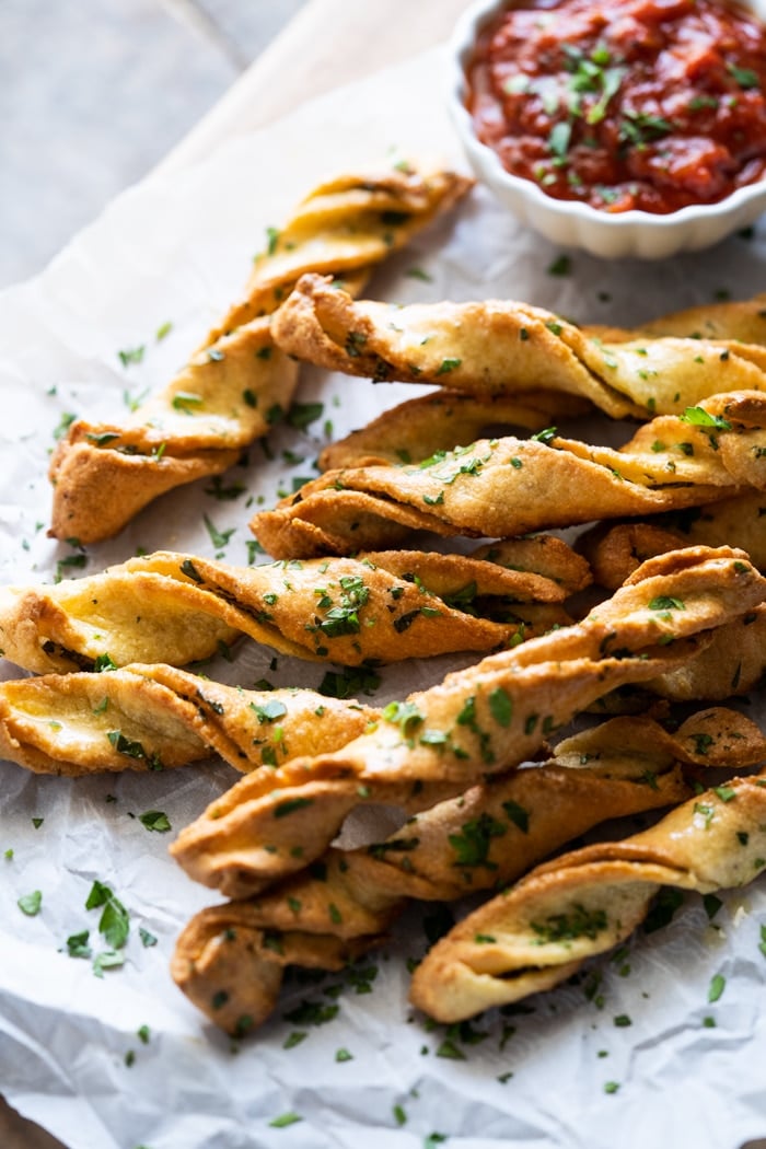 Dairy free & keto breadsticks with fresh parsley and marinara sauce