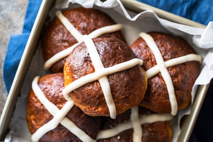 Piled up low carb hot cross buns in a gold baking dish