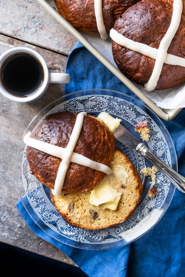 Overhead shot halved keto hot cross bun with a pat of butter