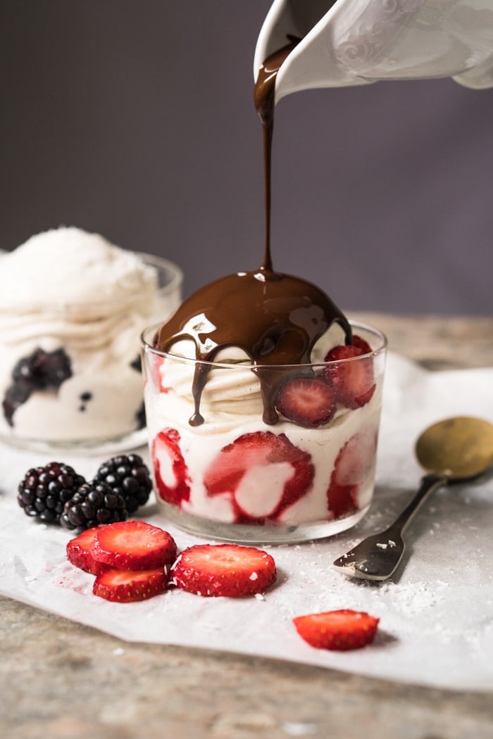 Drizzling chocolate onto keto frozen yogurt