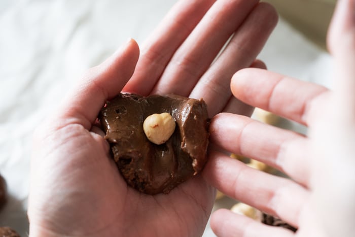 Folding in the hazelnut center of the Ferrero Rocher