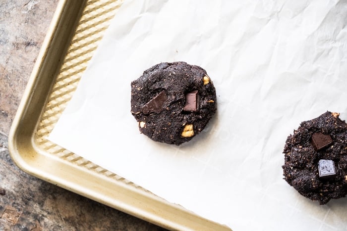 Unbaked keto chocolate cookie dough on a baking tray with parchment