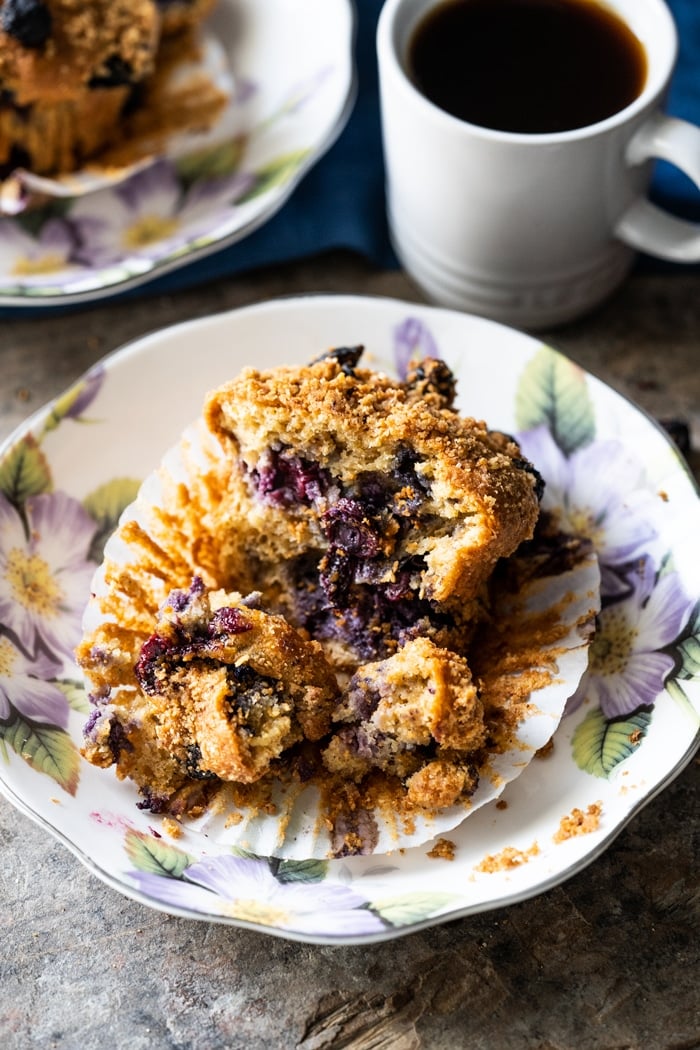 Keto muffin on a flower plate bursting with blueberries