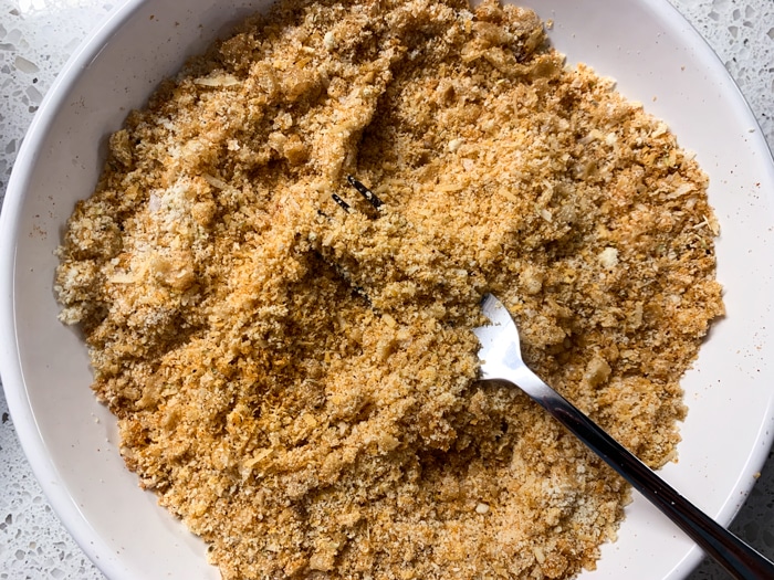 Bowl with crushed pork rinds and a fork