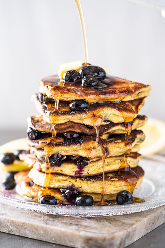 A stack of keto blueberry pancakes with sugar free syrup