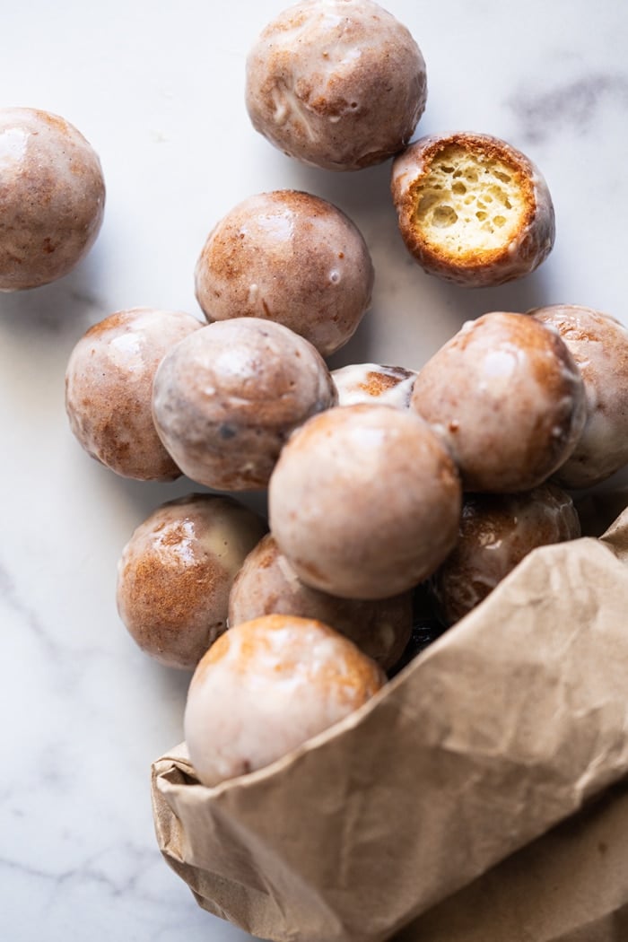 Glazed keto donut holes in a paper bag