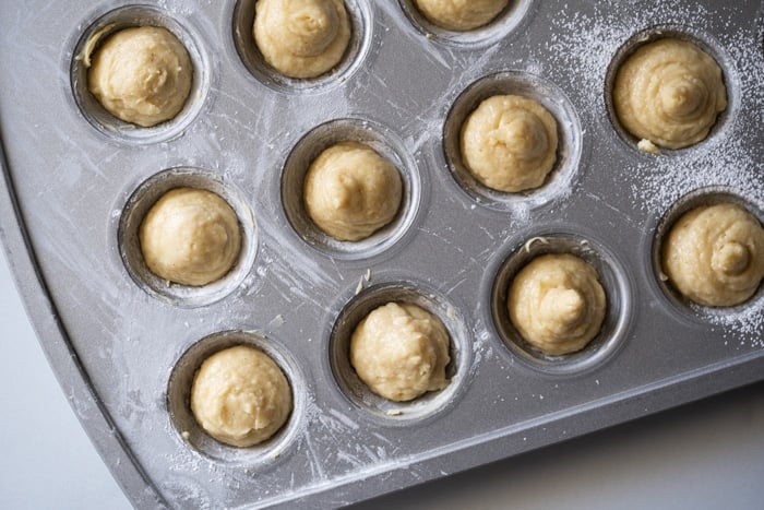 Unbaked keto donut holes on a silver pan