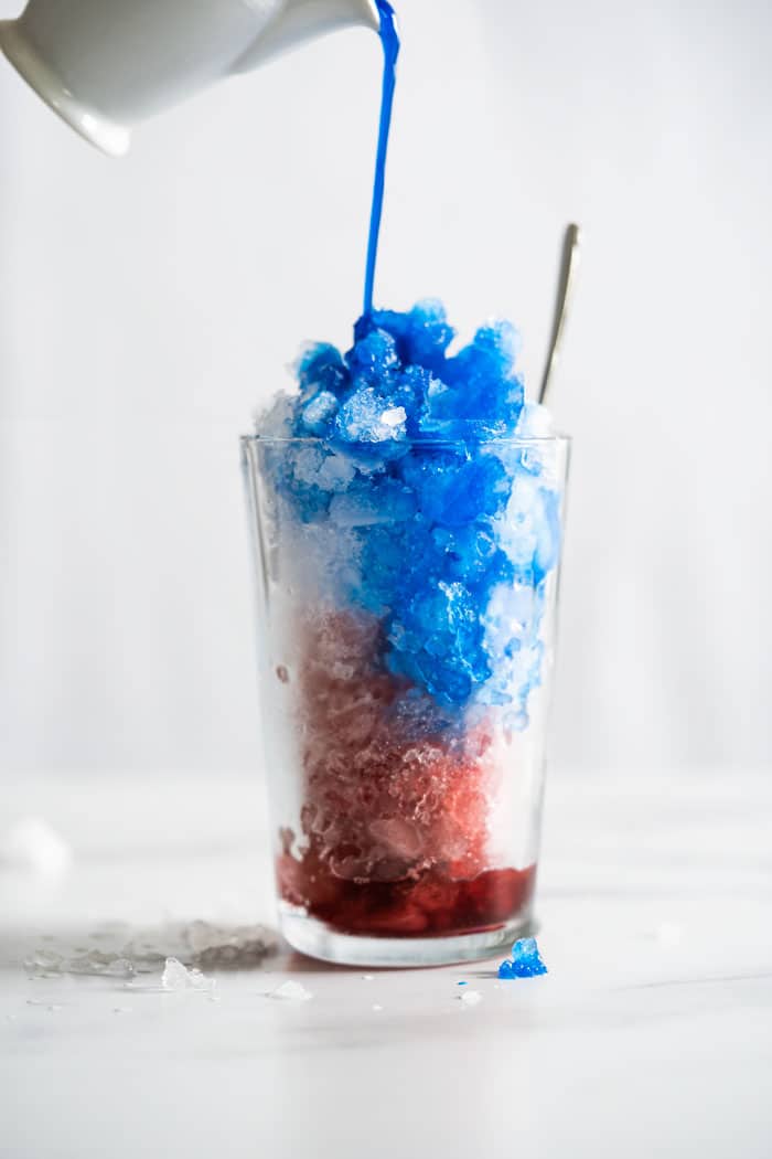Pouring blue spirulina onto keto slushie