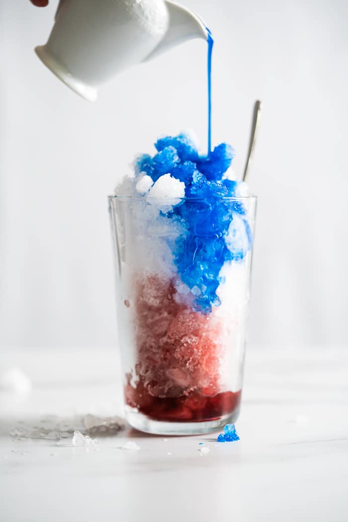 Pouring blue spirulina onto keto slushie