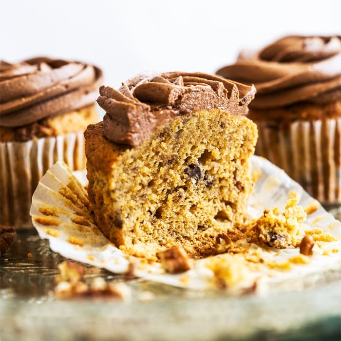 Keto banana cupcake with chocolate frosting sliced in half