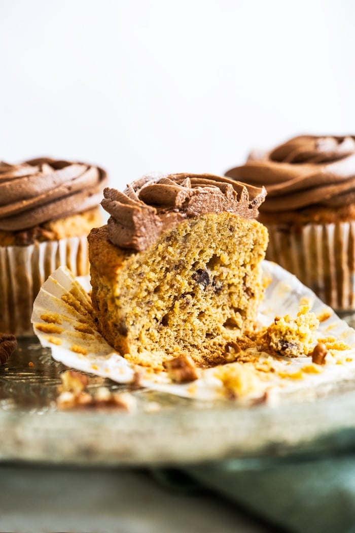 Keto banana cupcake with chocolate frosting sliced in half