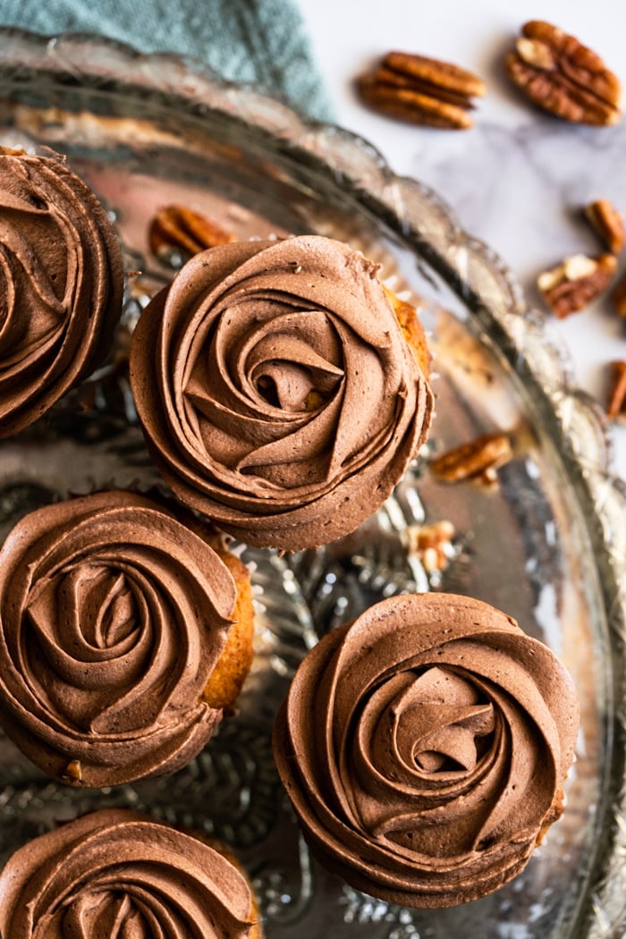 Overhead shot keto banana bread cupcakes with chocolate buttercream flowers