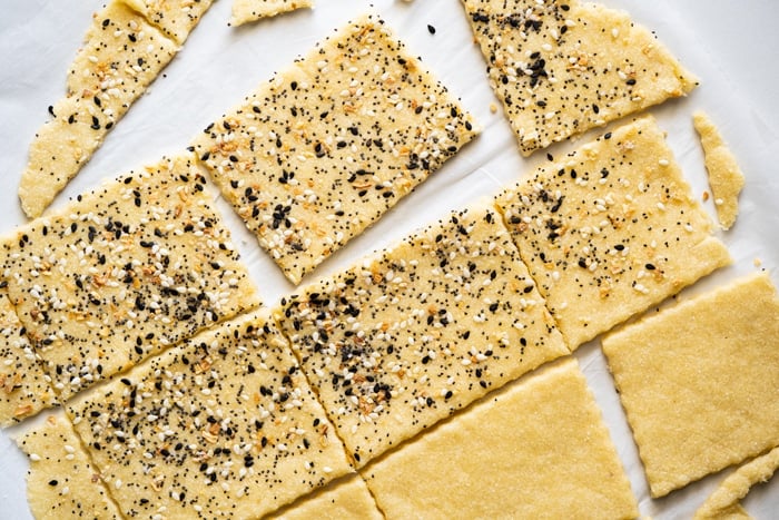 Uncooked keto dough being cut into rectangles