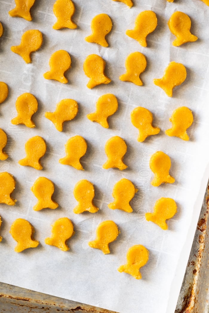 Unbaked keto goldfish crackers on parchment paper