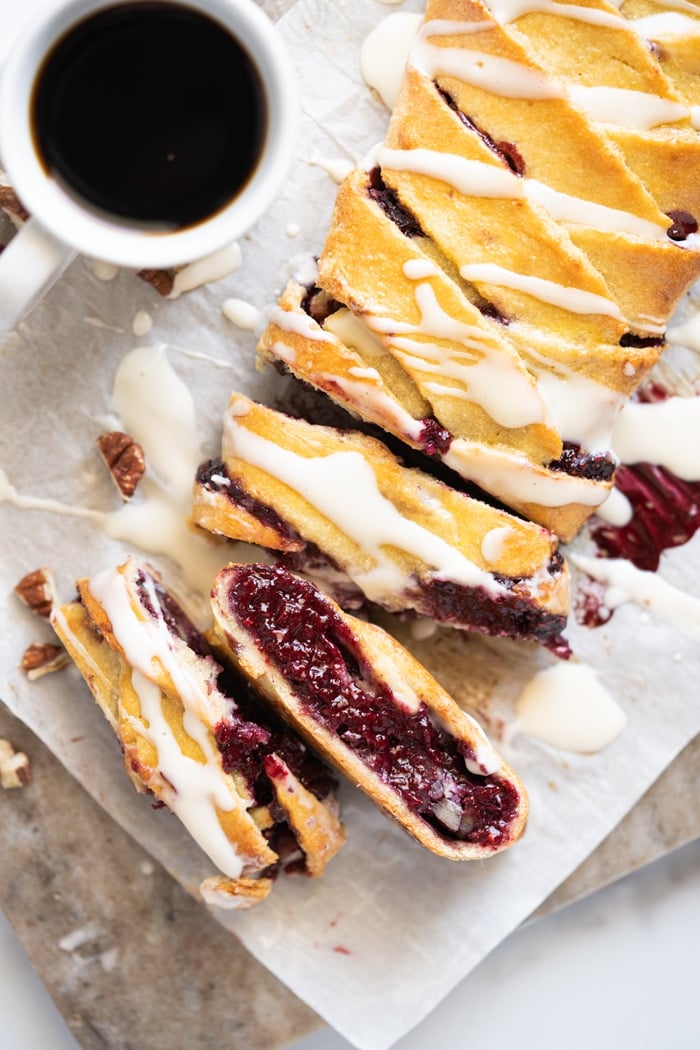 Sliced keto danish with cream cheese glaze and a mug of coffee