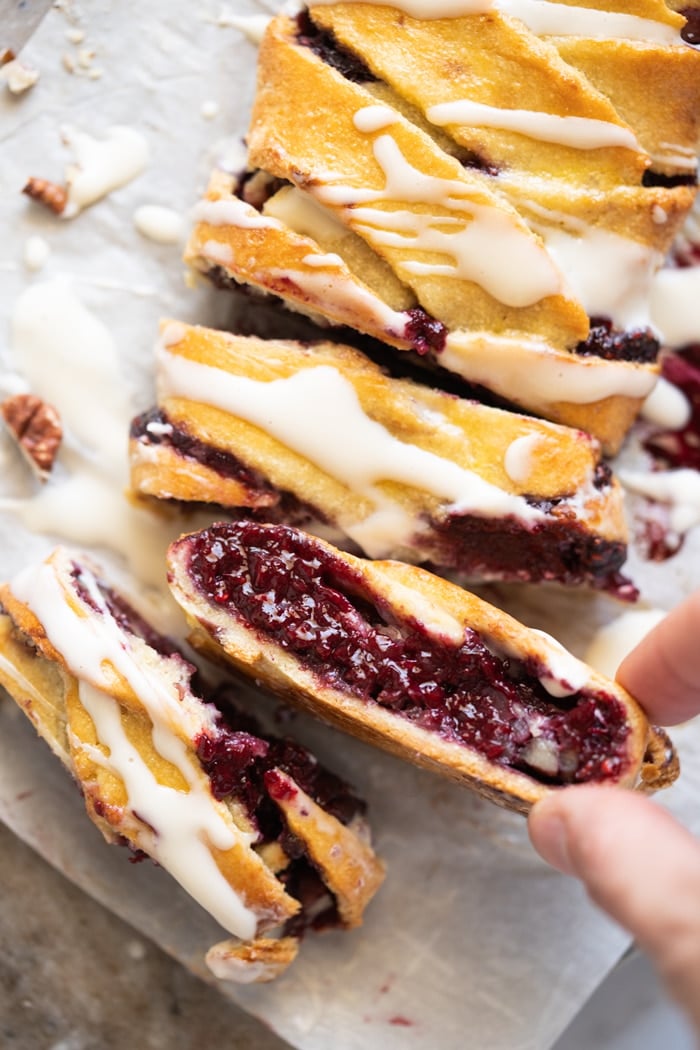 Taking a slice of keto danish with raspberry chia jam filling