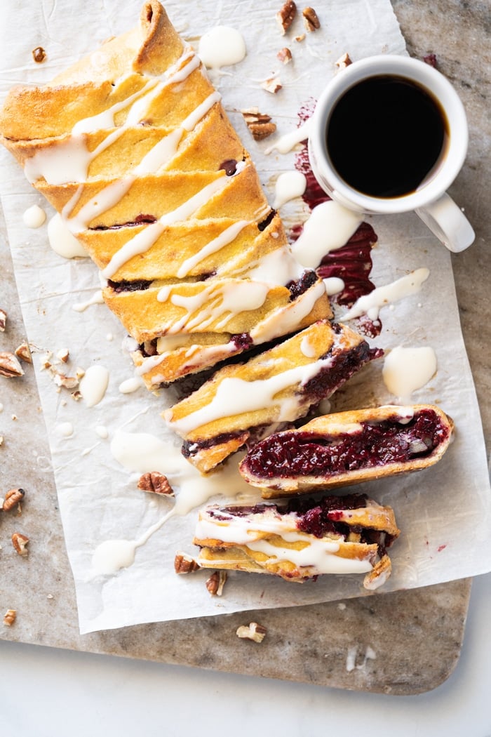 Sliced keto danish with cream cheese glaze and a mug of coffee