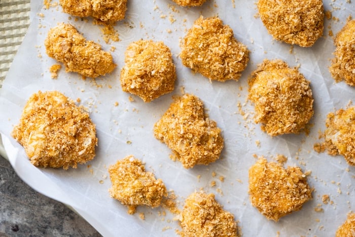 Unbaked keto chicken nuggets on a baking tray