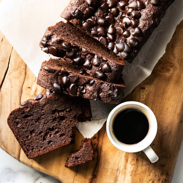 Sliced keto chocolate zucchini bread with a cup of coffee