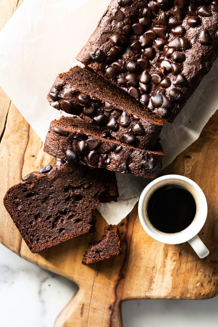Sliced keto chocolate zucchini bread with a cup of coffee