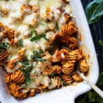 Keto cheesy pasta bake with radiatori in a white baking dish