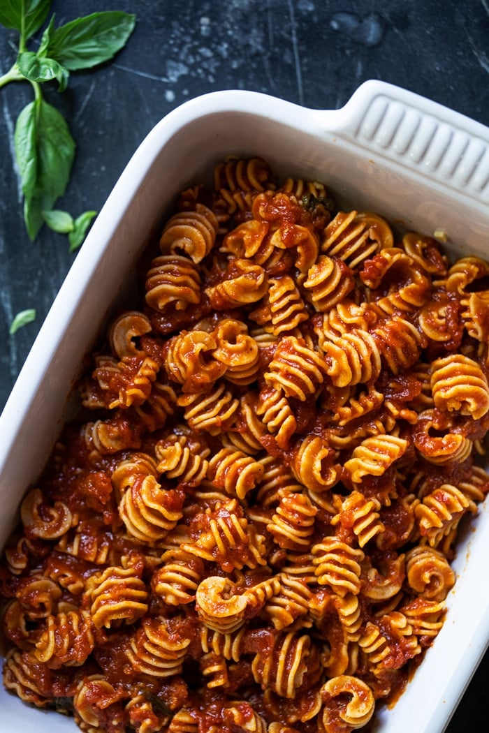Keto radiatori shaped pasta with marinara sauce in a white baking dish