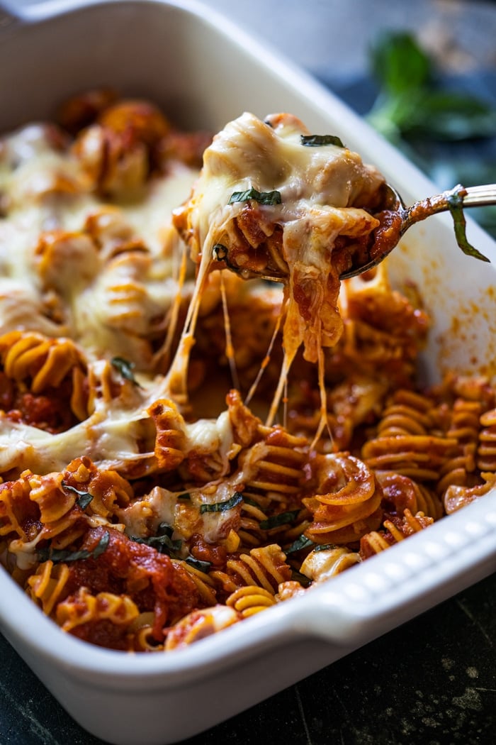 Taking a spoonful of keto cheesy pasta bake