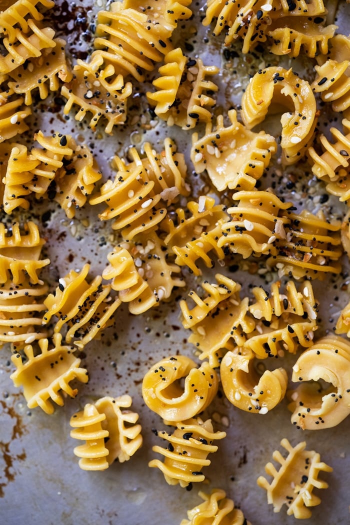 Keto Gnooda pasta with olive oil and seasoning on a baking tray