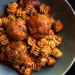 Keto meatballs with low carb radiator pasta in a green bowl