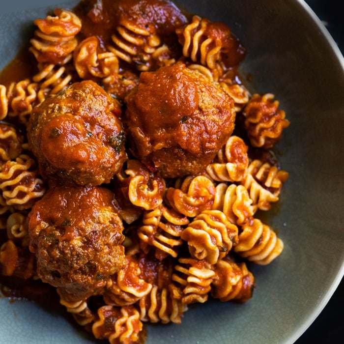 Keto meatballs with low carb radiator pasta in a green bowl