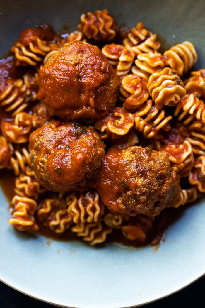 Keto meatballs with low carb radiator pasta in a green bowl