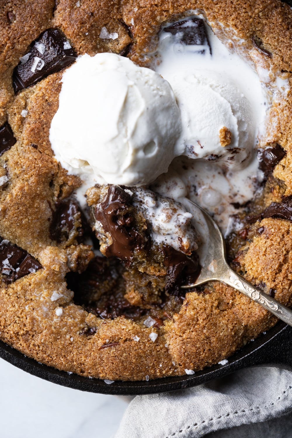 Taking a spoonful of keto chocolate skillet cookie with ice cream