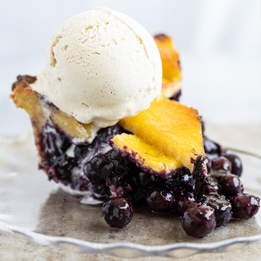 Gluten Free & Keto Blueberry Pie (with a flaky lattice pie crust!) and a scoop of vanilla ice cream on top