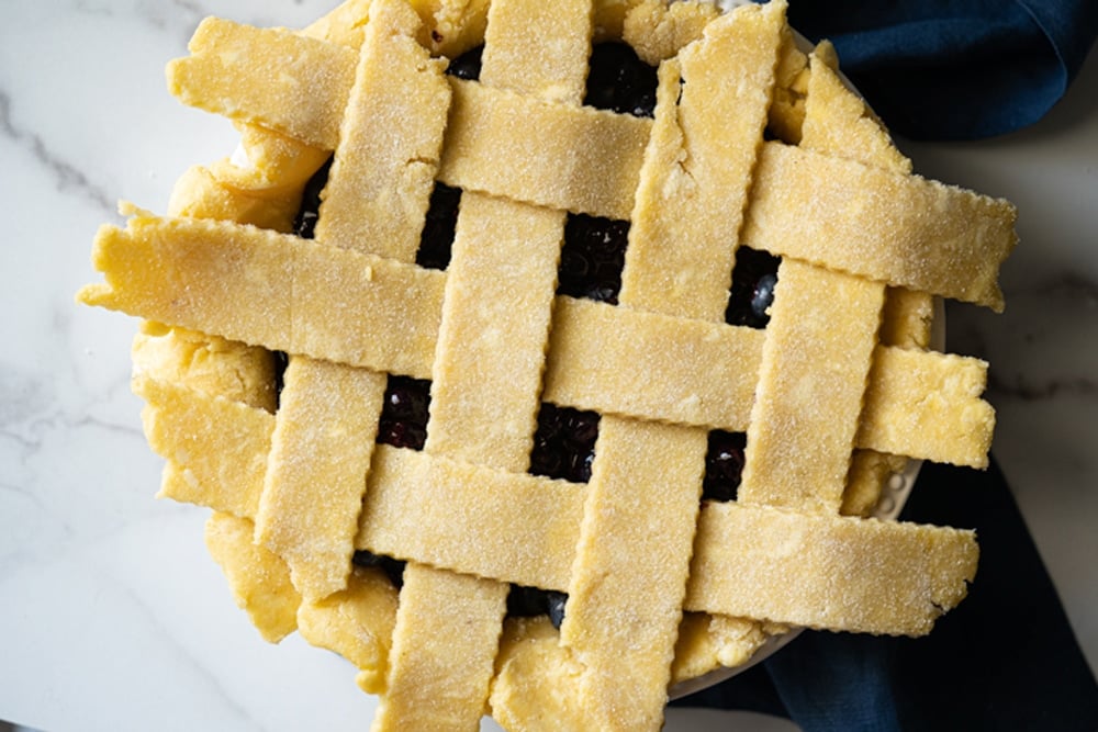 Overhead shot showing how to weave a keto lattice pie crust