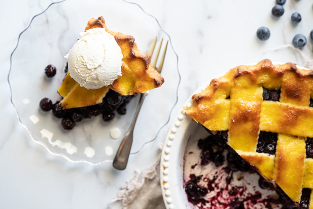 Overhead shot of a slice of Keto Blueberry pie with a scoop of vanilla ice cream
