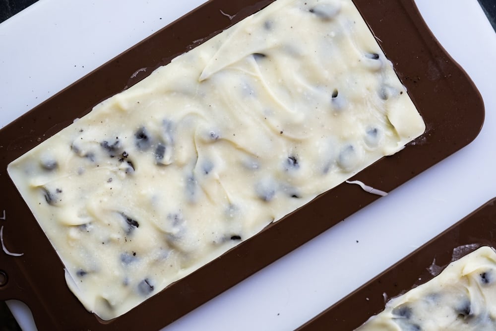Spreading melted Keto white chocolate over cookie crumbles