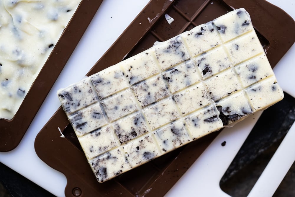 Demolding a keto cookies 'n' creme candy bar 