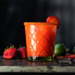 A paleo and keto strawberry margarita with a spicy Tajin rim