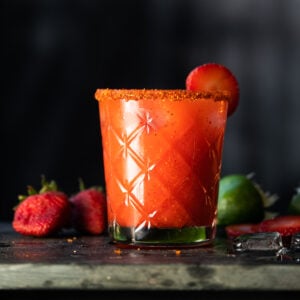 A paleo and keto strawberry margarita with a spicy Tajin rim