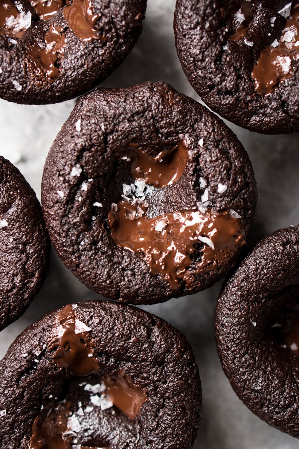 Freshly baked keto chocolate muffins with gooey chocolate and flaky sea salt