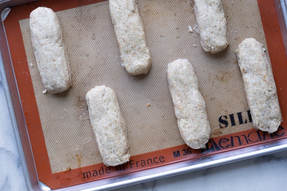 Keto hot dog buns with yeast before rise on a baking tray