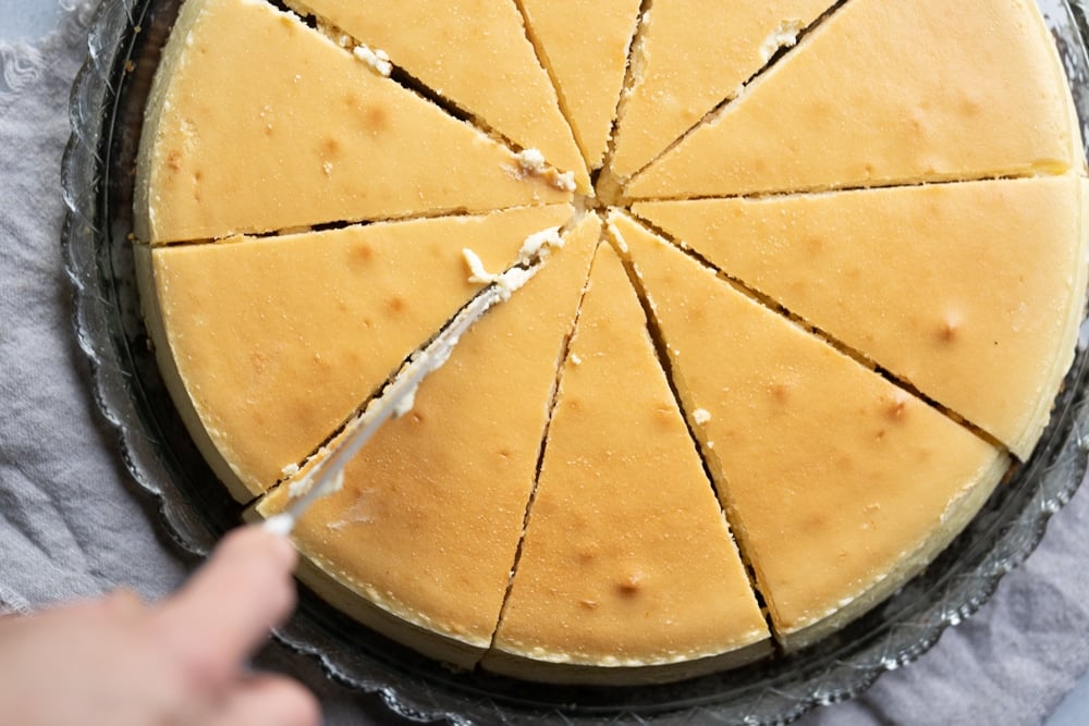 Slicing a freshly baked Keto Cheesecake with allulose