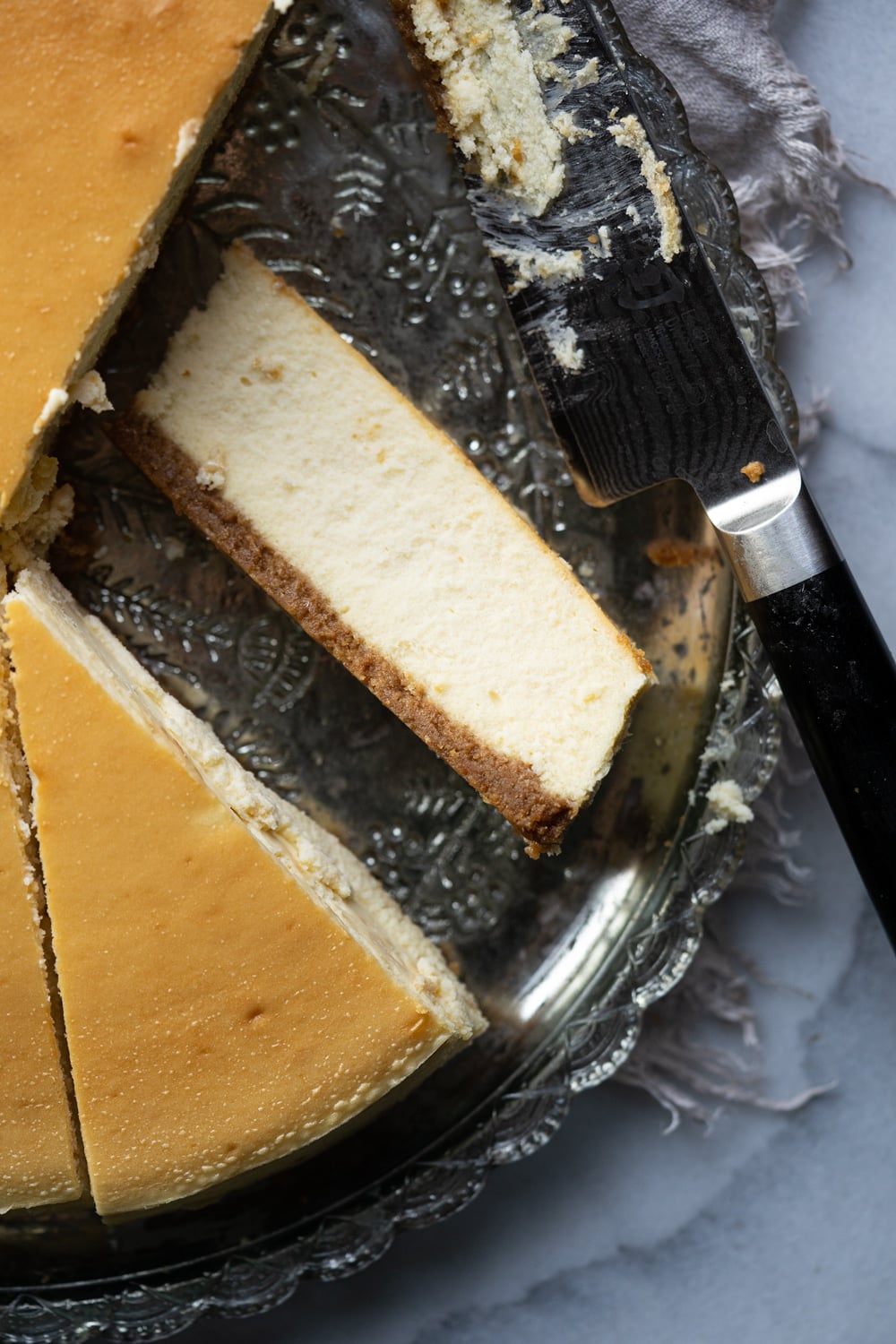 A slice of the best Keto Cheesecake showing a perfect creamy and airy texture
