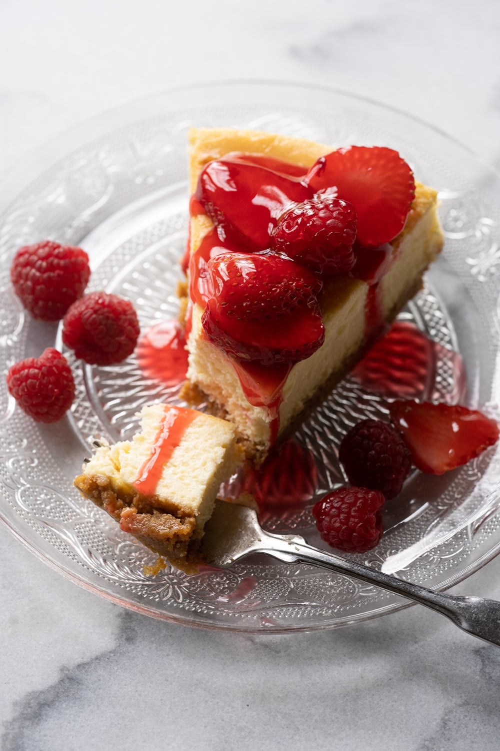 Taking a bite out of a Keto Cheesecake topped with fresh berries