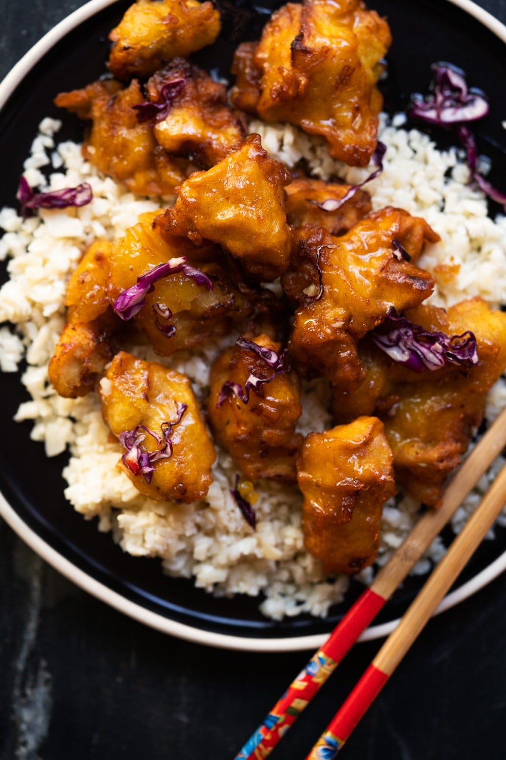 Keto orange chicken with sticky sauce served with cauliflower rice