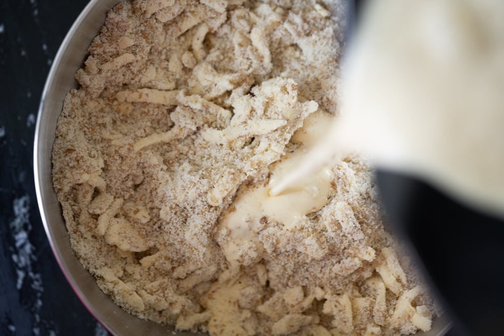 Adding egg mixture into butter and flours for keto shortcakes