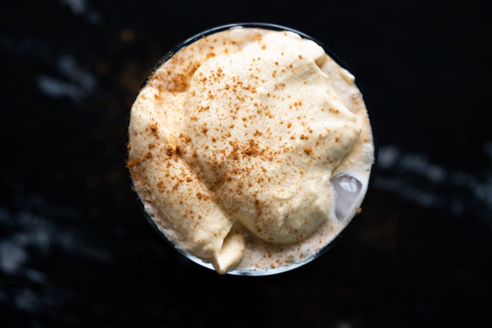 Overhead shot of keto pumpkin cream cold brew with a dusting of pumpkin spice